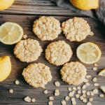 Lemon Oatmeal No-Bake Cookies on a rustic table with lemon slices and oats.